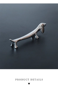 Macro shot of silver dachshund dog shaped stainless steel chopstick rest for table decor
