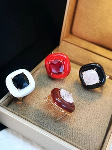 Detailed display of enamel square stud earrings in red black white and brown colors
