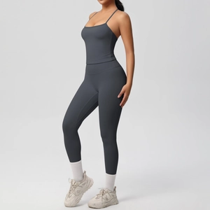 Detail view of charcoal grey yoga set featuring high-waist leggings and a strappy sports top