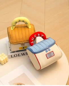 Detailed macro view of quilted makeup bags with LUCKY embroidery and animal patches