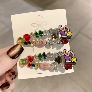 Detail of handmade hair clips with colorful rhinestones and crystal smile charms