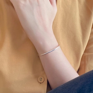 Minimalist S925 sterling silver thin geometric open bangle worn on a model's wrist