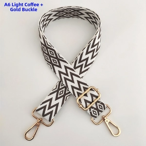 Detail of light coffee wavy pattern bag strap with adjustable golden buckle