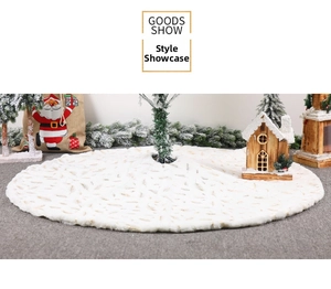 Detail of white faux fur Christmas tree skirt with gold foil feather patterns and soft texture