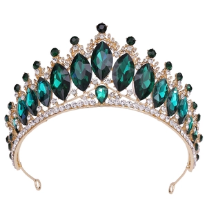 Close-up of vintage gold bridal tiara with marquise green crystals and white diamonds