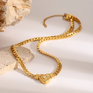 Gold stainless steel heart pendant necklace with radiant texture and diamond accents
