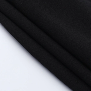 Close-up of the black knitted fabric texture showing premium softness and weaving detail