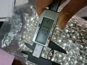 Macro shot of silver heart pendant measured with a digital caliper showing 19.3mm diameter