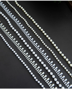 Detailed macro view of ivory and beige pearl bead strands with round and teardrop shapes