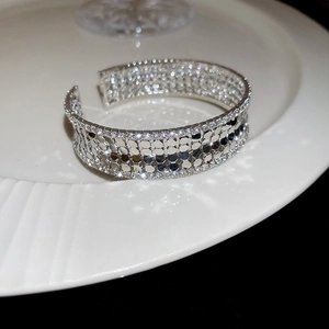Close-up of wide silver mesh open bangle with multi-row sparkling zircon stones
