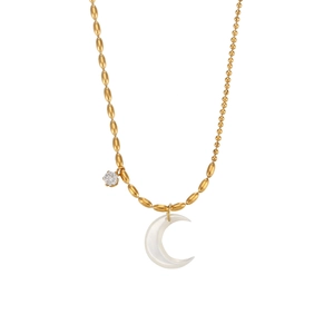 Asymmetric gold necklace with shell crescent pendant and zircon detail on white background