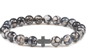 Detail of hematite cross charm and grey cracked beads on a men's beaded bracelet