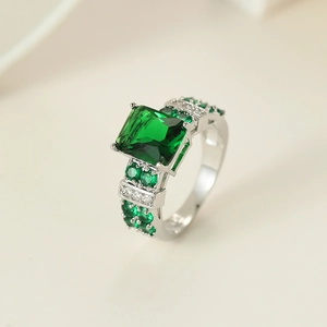 Detail of emerald cut green zircon ring with silver punk setting and micro-pave stones