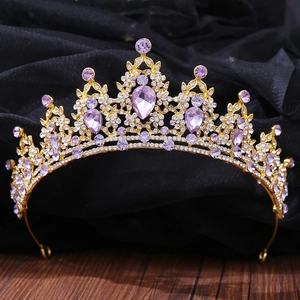 Detail of luxury bridal tiara with purple crystals and gold metal on black background