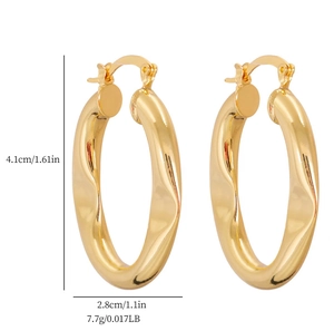 Detailed view of chunky golden wavy hoop earrings with size measurements in centimeters