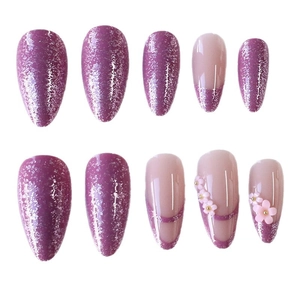 Pink and purple almond press-on nails with glitter French tips and 3D floral accents