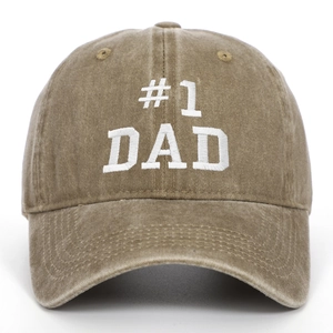 Detailed view of white #1 DAD embroidery on a vintage washed khaki cotton baseball cap