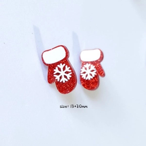 Detailed macro view of 13x20mm red glitter Christmas glove charms with snowflake patterns