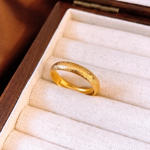 Détail de la bague en or 24K plaqué sur présentoir en lin dans un coffret à bijoux en bois