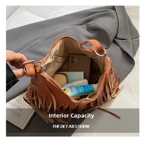 Internal view of brown textured leather crossbody bag showing large storage capacity for items