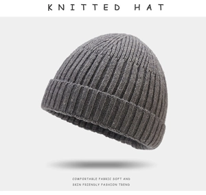 Detailed macro view of the grey knitted beanie hat showing thick ribbed texture