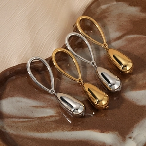 French style gold and silver waterdrop earrings on marble tray with polished finish