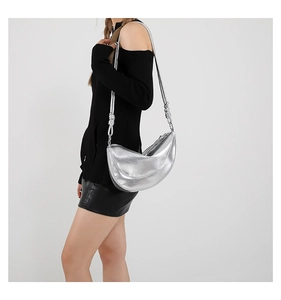 Close-up of silver hobo bag with metallic crinkle texture and unique knotted shoulder strap