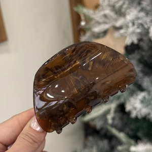 Close-up of tortoise shell pattern acetate hair claw clip with glossy finish