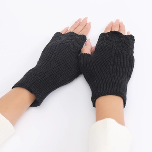 Detail shot of black knitted fingerless gloves with scale texture for winter warmth
