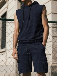Close-up of navy sports set showing textured sleeveless hoodie and cargo pocket detail