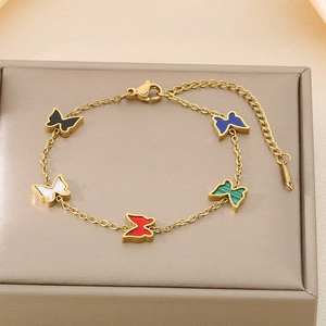 Detailed close-up of a golden butterfly bracelet featuring vibrant multi-color shell charms