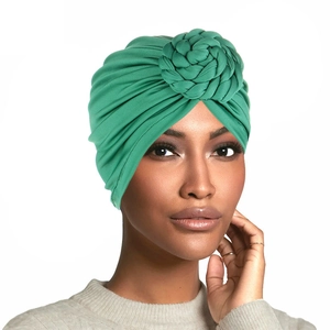 Women's pleated green turban hat featuring a decorative braided flower design on the top