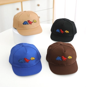 Detail of children's flat brim baseball caps featuring colorful cartoon dinosaur embroidery
