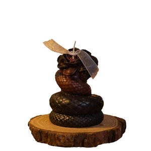 Handmade snake and rose scented candle in black and brown wax on wooden base
