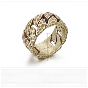 Macro detail of men's stainless steel ring with vintage hammered texture and matte finish
