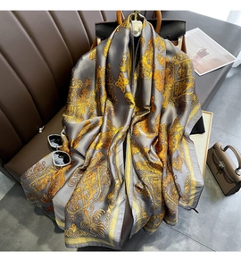 Detailed macro view of the golden vintage pattern on gray silk scarf with elegant classic motifs