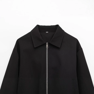Minimalist black zip-up bomber jacket with collar and textured fabric detail