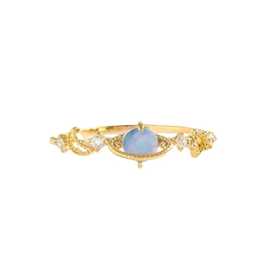 Artistic blue planet Saturn ring in golden metal with sparkling side crystals
