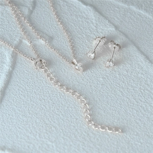 Macro detail of S925 sterling silver heart necklace and matching earrings set
