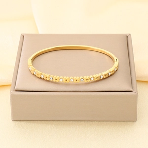 Elegante bracciale rigido in acciaio inox dorato con inserti in cristallo per donna