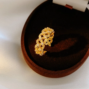 Detailed macro view of 18k gold plated hollow flower ring with cubic zirconia stones