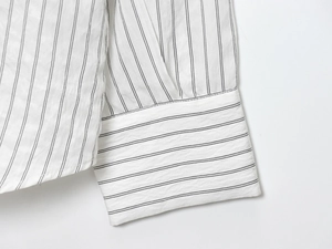 Detailed close-up showing the striped patterns and stitching on the shirt cuff