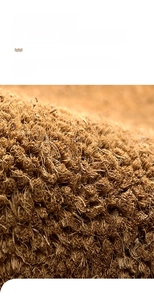 Macro detail of thick coconut fiber texture on natural coir entrance door mat