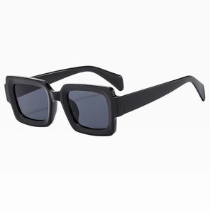 Detail view of bold black square frame sunglasses with dark lenses and thick temples