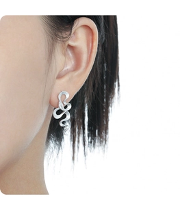 Close-up of S925 sterling silver snake textured earring with zircon on model's ear