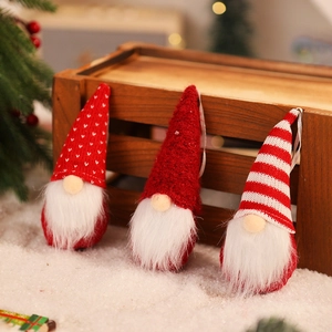 Three Christmas gnomes with knitted hats leaning on a rustic wooden crate