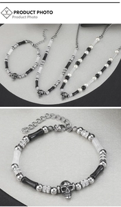 Macro detail of gothic beaded necklace and bracelet set with skull pendant and crystals