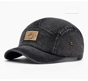 Detail view of black denim baseball cap with side metal eyelets and side profile