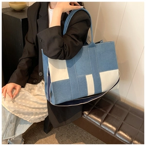Blue denim and white canvas tote bag shown on model for daily commuting style