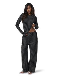 Detail of striped long sleeve top and wide leg trousers with soft knit fabric texture